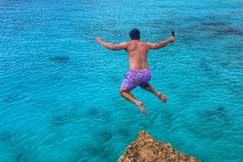 Tyler Fox jumping off cliff at Boca Slagbaai in Bonaire