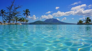 View of the Nevis Peak volcano from a swimming pool in Christopher Harbour, St Kitts