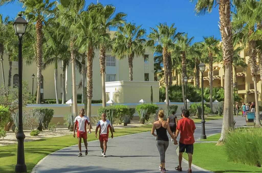 American Tourists Walking Past Staff at Resort in Cabo San Lucas