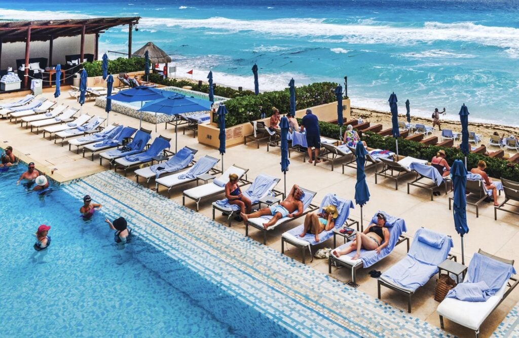 American vacationers enjoy the pool at a resort in Cancun