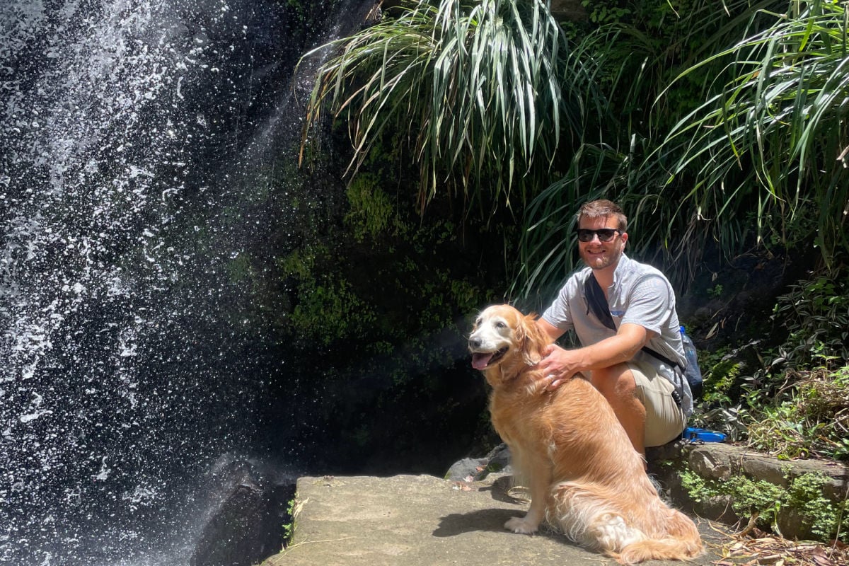 Managing Editor Tyler Fox in Grenada with golden retriever Nala at Annandale Falls