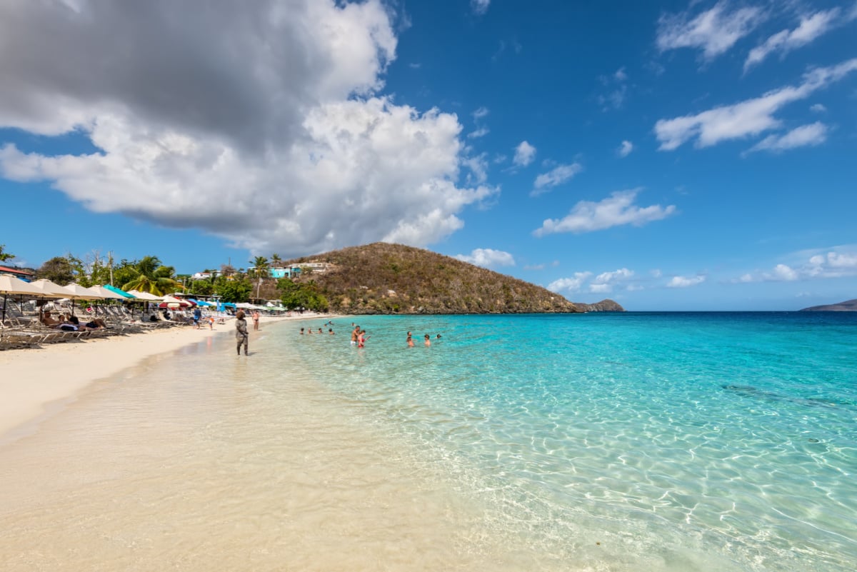 People relax on the Coki Point Beach in St Thomas, USVI, Caribbean. Tourism is a major industry in St Thomas.