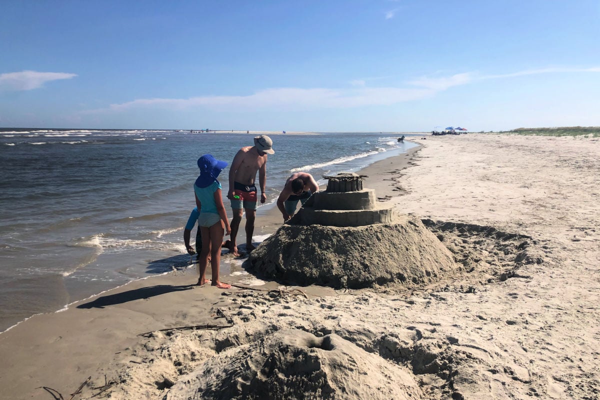 Tyler Fox with family building a sandcastle in Fripp Island, South Carolina