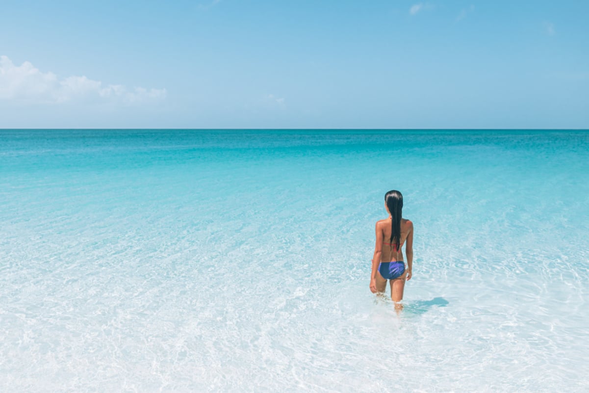 Woman walking into the ocean in South Caicos
