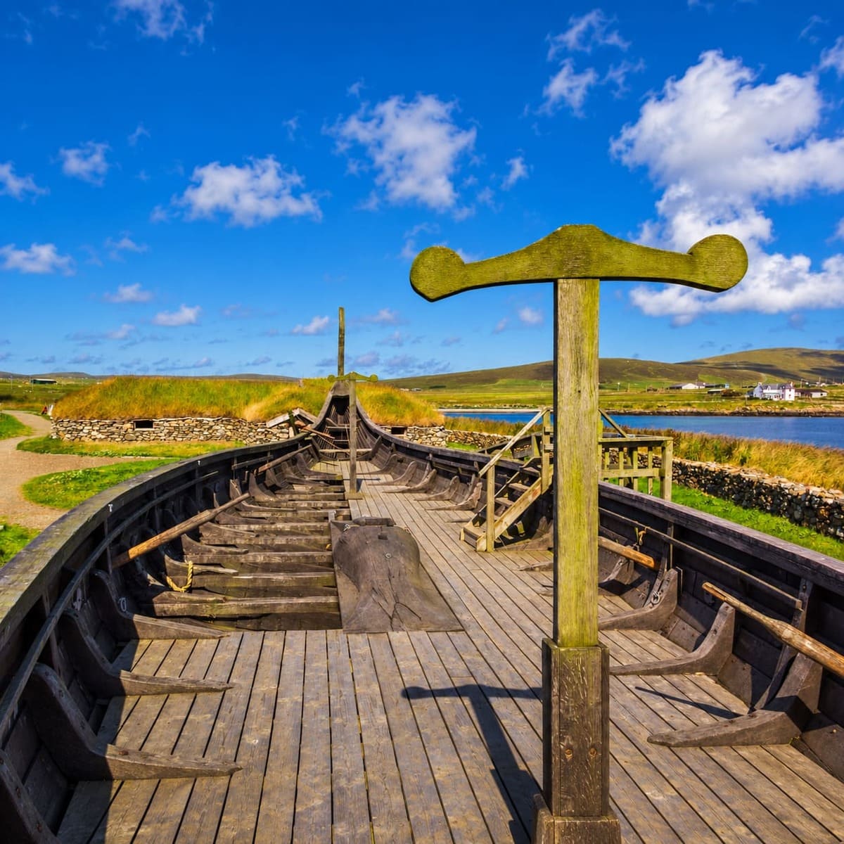 A Long Boat Topped With A Cross In Shetland, Scotland