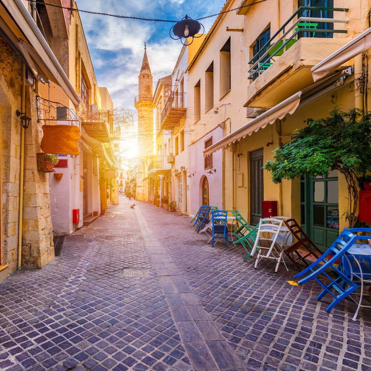 A Narrow Street Lined With Bars Leading To Ahmet Aga Minaret In Chania, Crete, Greece