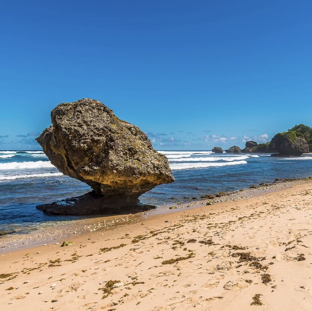 A view past wave cut boulders on Bathsheba Beach on the Atlantic coast of Barbados