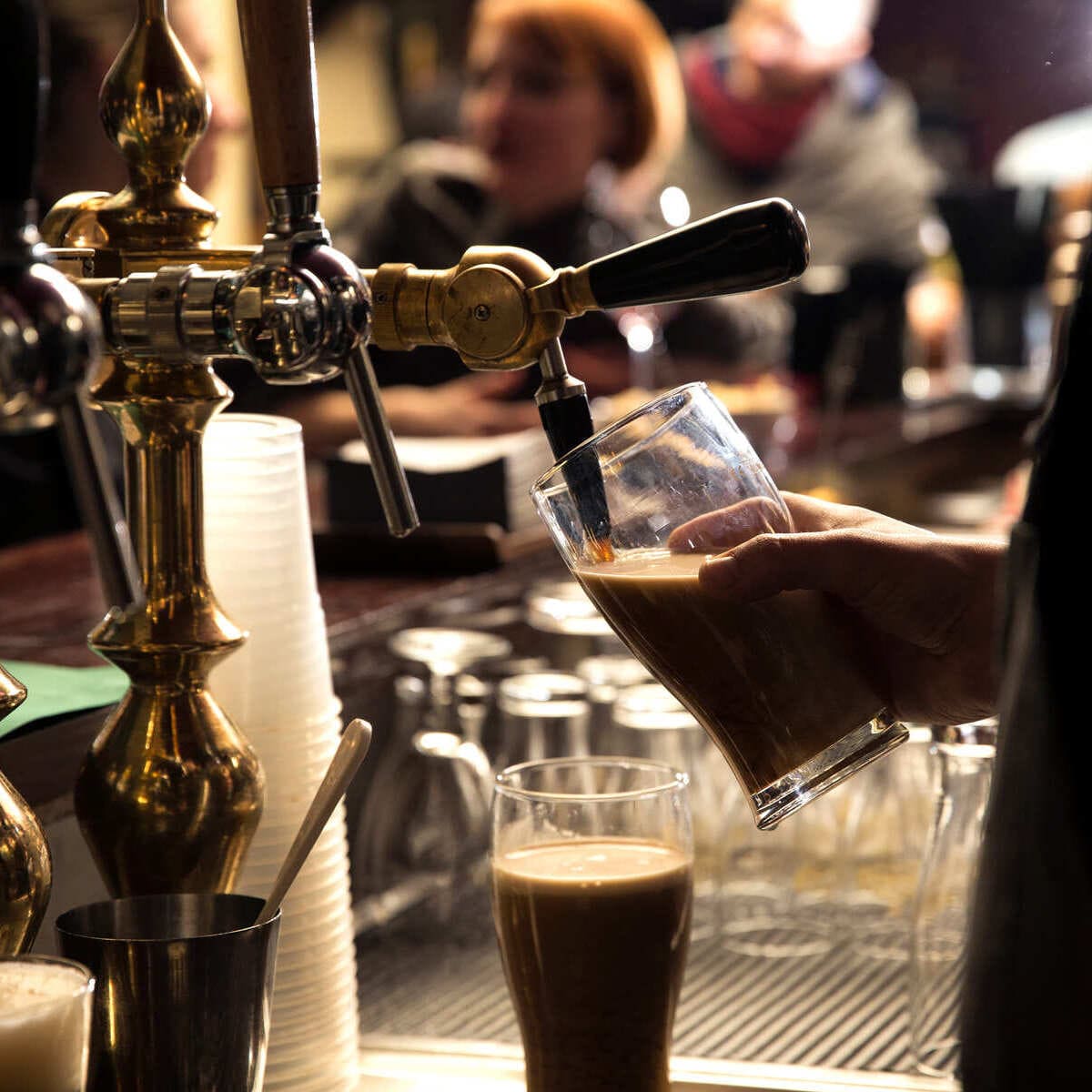 Bartender Pouring A Pint Of Guinness In Ireland
