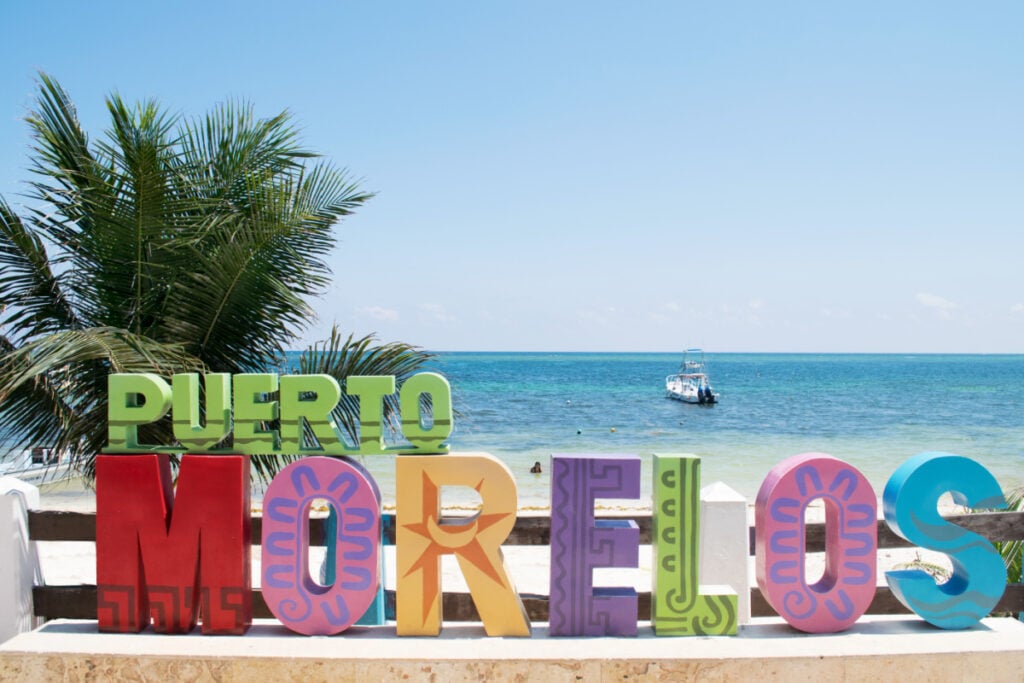 Boat-Drifting-in-the-Water-Behind-the-Puerto-Morelos-Sign