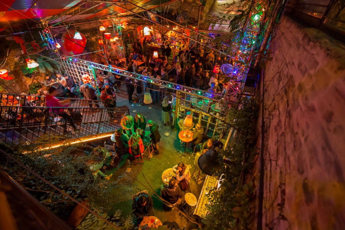 Budapest:Hungary indoor terrace with people drinking in a ruin bar
