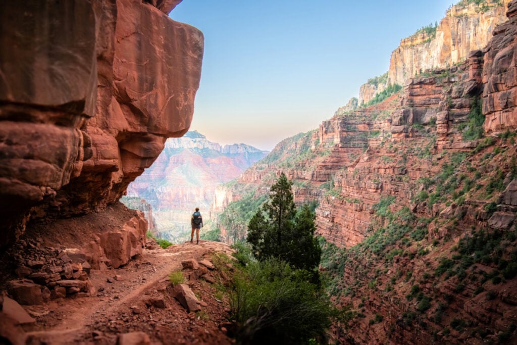 Hiker Stands At An Overlook Along North Kaibab Trail below the North Rim