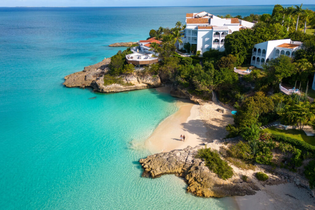 Meads Bay Beach, Anguilla. Turquoise blue sea with crystal clear and calm waters. Beautiful sunny day with calm sea. Beach with many trees and shade to relax.
