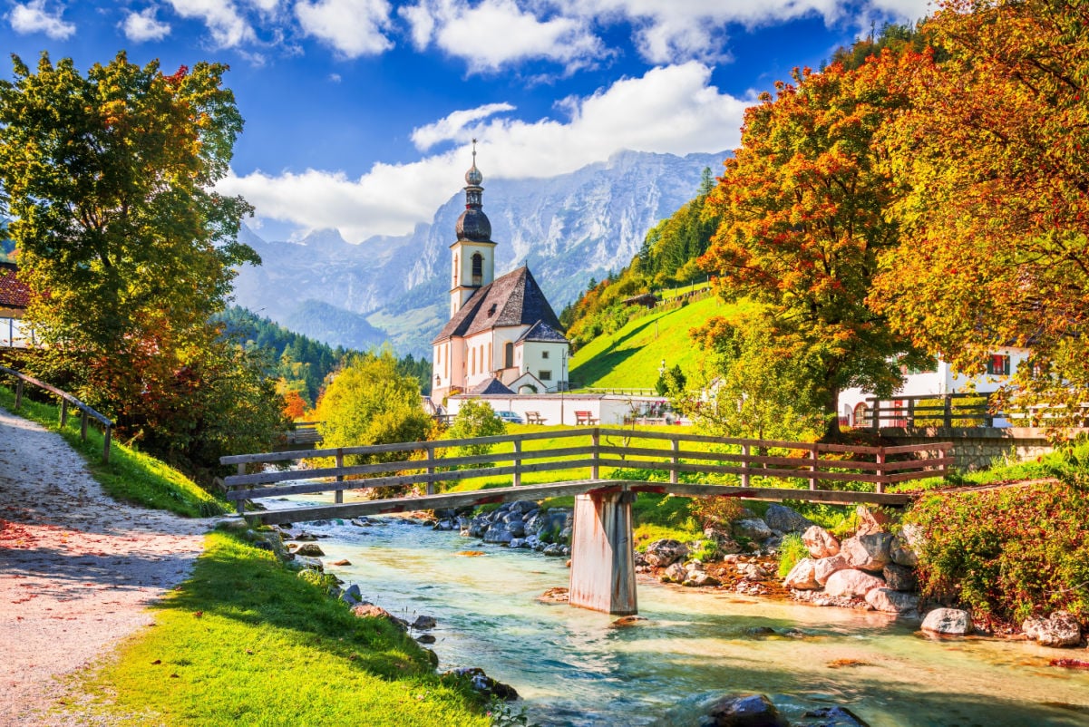 Ramsau, Berchtesgaden - Germany. Autumn scenery in Bavaria with Parish Church of St. Sebastian and River Ramsauer Ache.