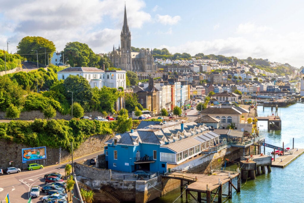 St. Colman's Cathedral and the skyline of the seaside city of Cobh, Ireland, the Titanic's last port of call, seen from the harbor and cruise port.