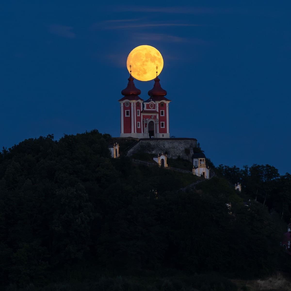 The Moon Rising Over A Castle Church In Banská Štiavnica, Slovakia
