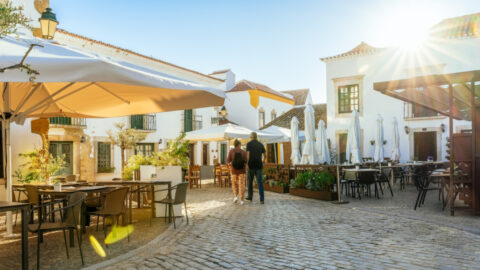 A tourist couple visiting Faro old town street