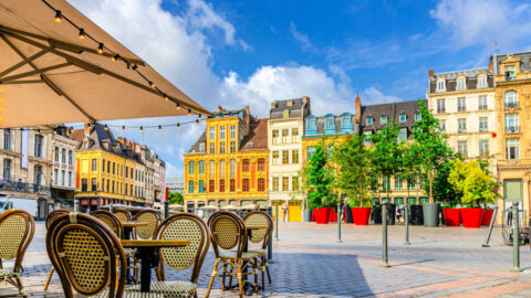 La Grand Place square in Lille city center, Flemish mannerist architecture style buildings, trees in pots, tables and chairs of street restaurant, French Flanders, Nord department, Northern France