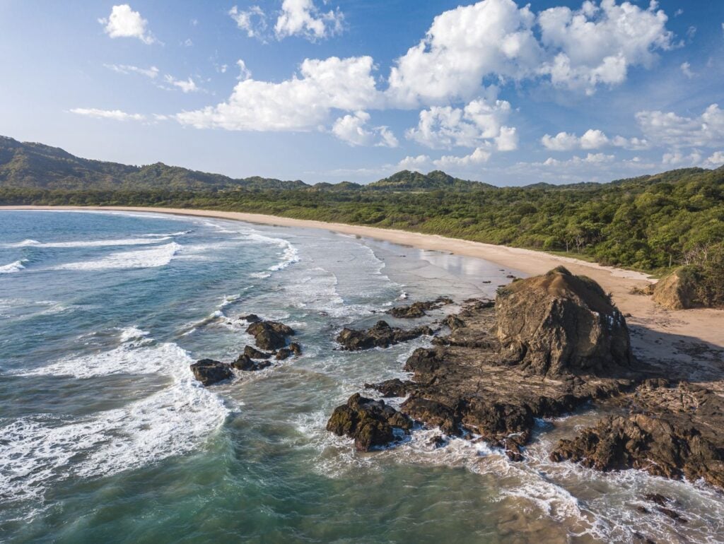 Playa Grande, Guanacaste, Costa Rica - Aerial Drone shot of large Tropical Beach with big Rocks