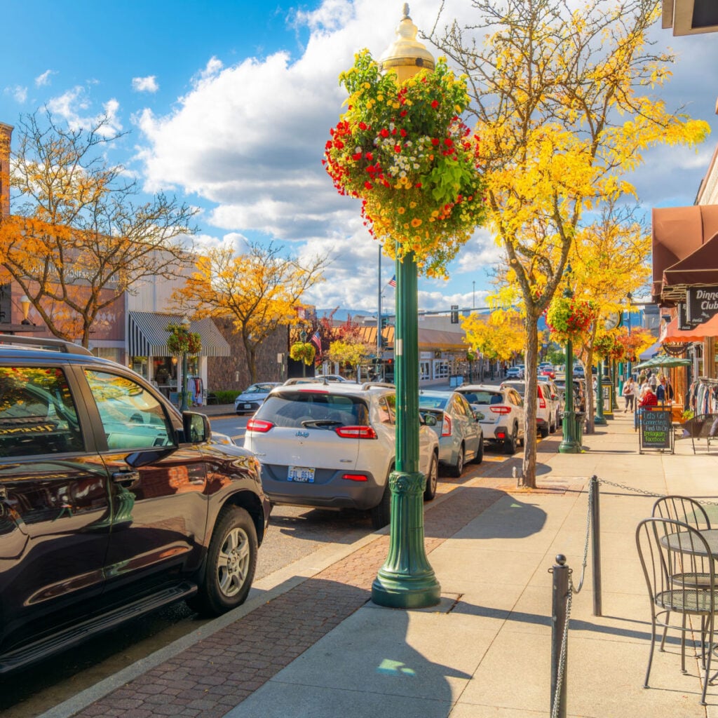 Shops and sidewalk cafes on Sherman Avenue in the lakeside small town of Coeur d'Alene, Idaho at autumn in the North Idaho panhandle region.