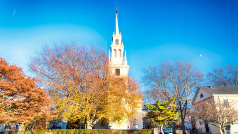 The landmark trinity church in Queen Anne Square in late autumn in Newport Rhode Island.