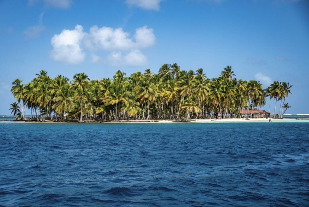 island surrounded by clear, blue water, in the San Blas Islands, Panama